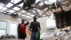 LAKE CHARLES, LOUISIANA - AUGUST 27: Latasha Myles and Howard Anderson stand in their living room where they were sitting when the roof blew off around 2:30am as Hurricane Laura passed through the area on August 27, 2020 in Lake Charles, Louisiana . The hurricane hit with powerful winds causing extensive damage to the city. (Photo by Joe Raedle/Getty Images)