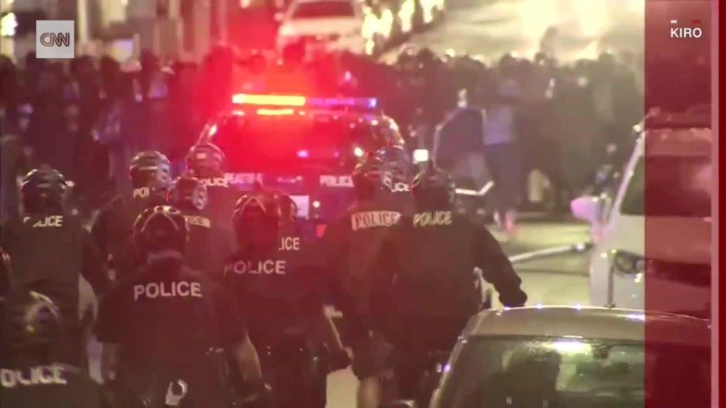 Video shows a policeman running over a protester