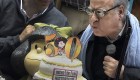 Cartoonist Joaquín Salvador Lavado known as Quino(R) blows the candle next to Mafalda the mythical rebellious and incisive girl created by him in Buenos Aires on September 29, 2014, during Mafalda 50 anniversary since its first publication. AFP PHOTO / DANIEL GARCIA (Photo credit should read DANIEL GARCIA/AFP via Getty Images)