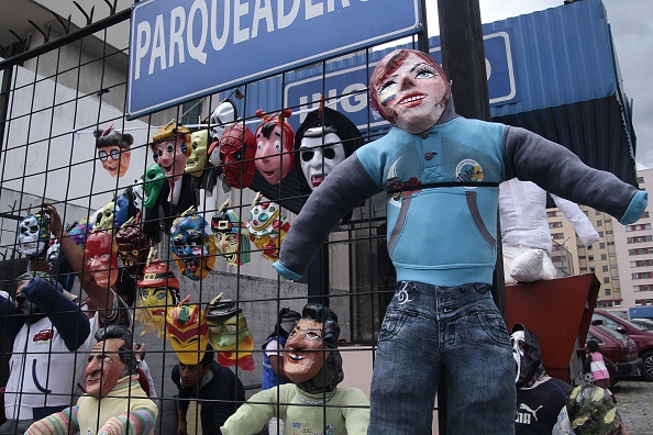 Picture taken during Ecuador's traditional New Year custom of burning dummies representing prominent politicians, sport personalities and artists in the belief that it brings good luck for the following year, in Quito on December 31, 2014. AFP PHOTO / JUAN CEVALLOS (Photo credit should read JUAN CEVALLOS/AFP via Getty Images)