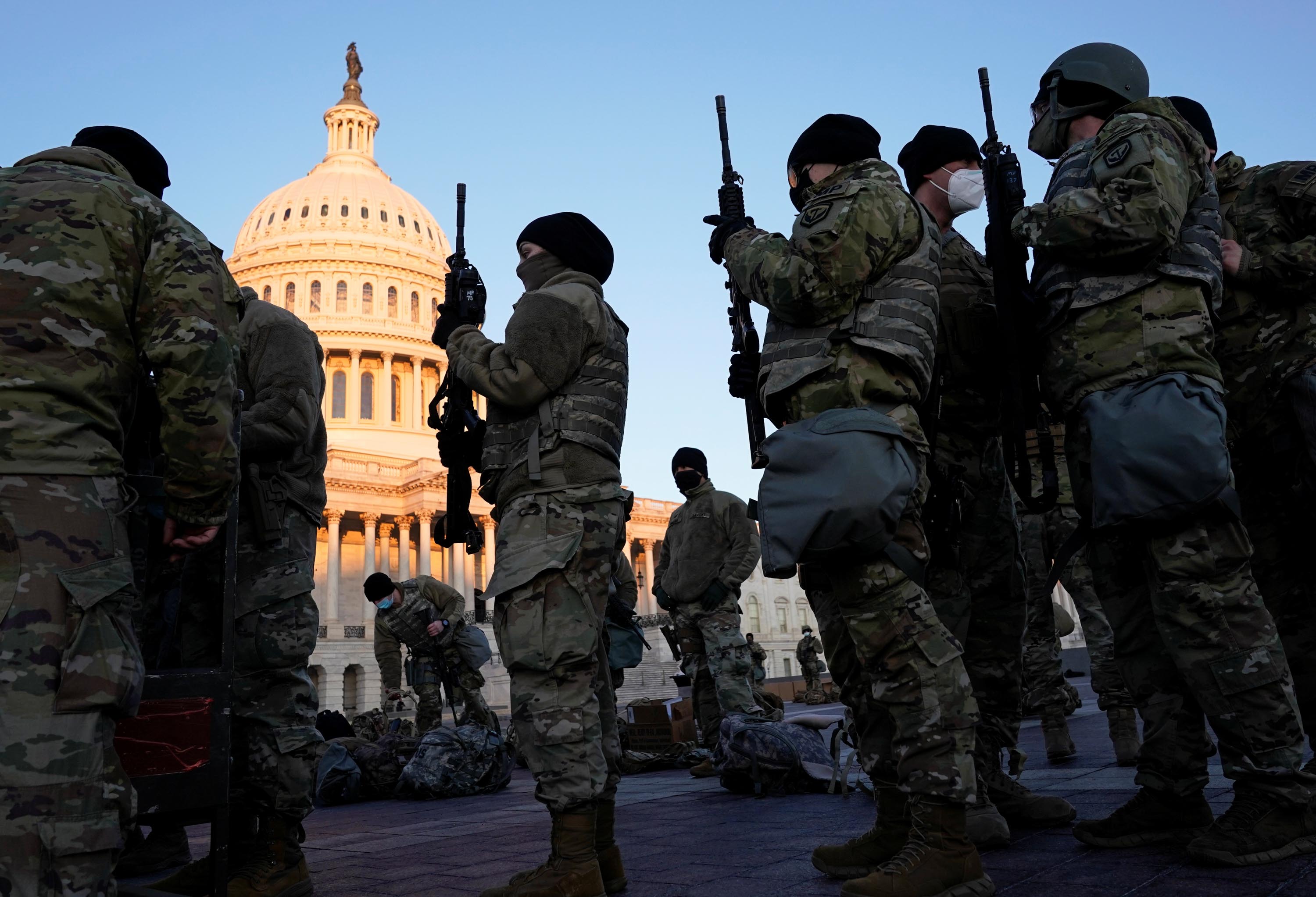 Members of the National Guard are given weapons before Democrats begin debating one article of impeachment against U.S. President Donald Trump at the U.S. Capitol, in Washington, U.S., January 13, 2021. REUTERS/Joshua Roberts