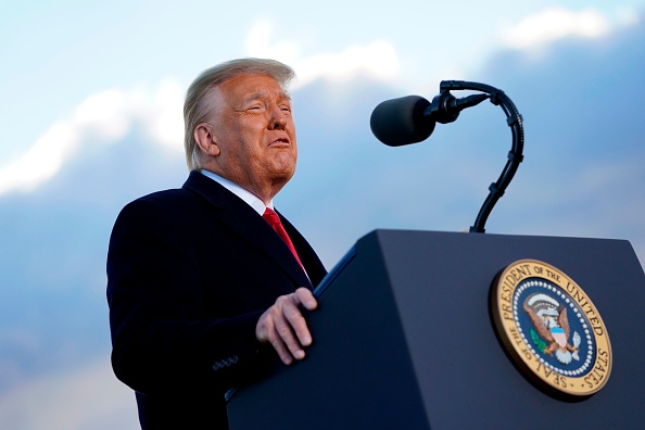 US President Donald Trump speaks before boarding Air Force One at Joint Base Andrews in Maryland on January 20, 2021. - President Trump travels to his Mar-a-Lago golf club residence in Palm Beach, Florida, and will not attend the inauguration for President-elect Joe Biden. (Photo by ALEX EDELMAN / AFP) (Photo by ALEX EDELMAN/AFP via Getty Images)