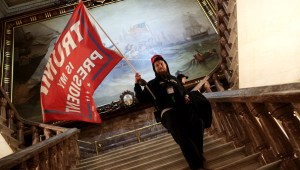 WASHINGTON, DC - JANUARY 06: A protester holds a Trump flag inside the US Capitol Building near the Senate Chamber on January 06, 2021 in Washington, DC. Congress held a joint session today to ratify President-elect Joe Biden's 306-232 Electoral College win over President Donald Trump. A group of Republican senators said they would reject the Electoral College votes of several states unless Congress appointed a commission to audit the election results. (Photo by Win McNamee/Getty Images)