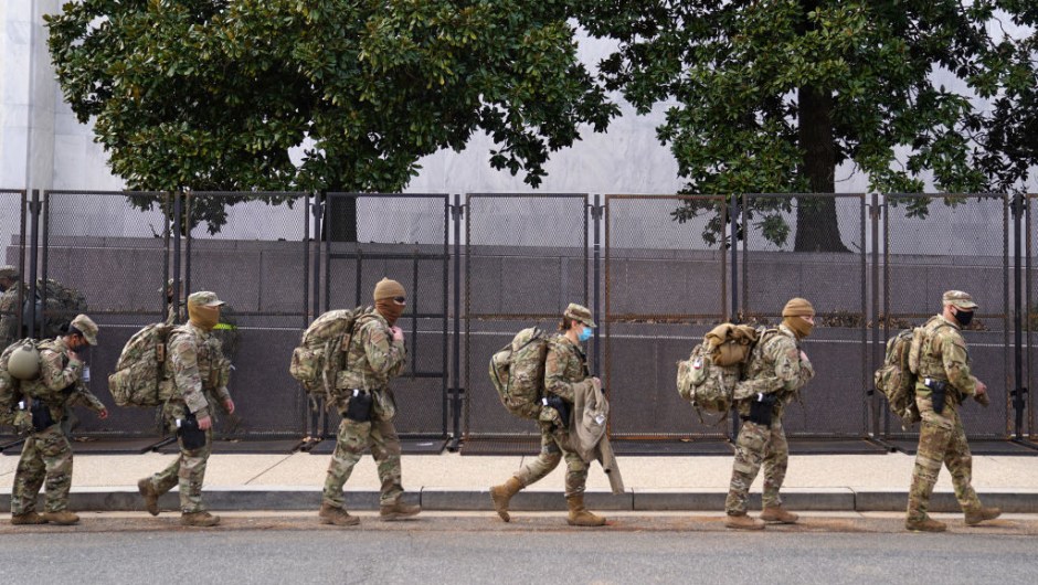 WASHINGTON, DC - JANUARY 16: National Guard troops march by security fencing near the U.S. Capitol on January 16, 2021 in Washington, DC. After last week's riots at the U.S. Capitol Building, the FBI has warned of additional threats in the nation's capital and in all 50 states. According to reports, as many as 25,000 National Guard soldiers will be guarding the city as preparations are made for the inauguration of Joe Biden as the 46th U.S. President. (Photo by Eric Thayer/Getty Images)