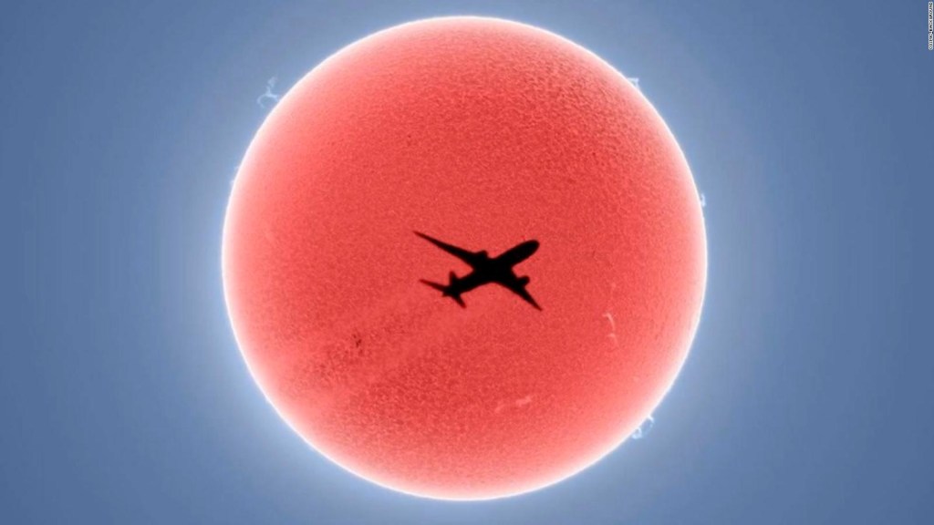 The moment an airplane passes over the sun