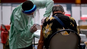 A health worker gives a shot of the Moderna vaccine at a Puerto Rico National Guard vaccination center during a priority Covid-19 vaccination program for the elderly, in San Juan, Puerto Rico on February 8, 2021. (Photo by Ricardo ARDUENGO / AFP) (Photo by RICARDO ARDUENGO/AFP via Getty Images)