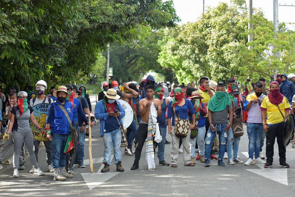 Indigenous people are seen during clashes with citizens who oppose blockades set by demonstrators during protests triggered by a now abandoned tax reform, in Cali, Colombia, on May 9, 2021. - Facing anti-government protests that have spiralled into deadly violence, Colombian President Ivan Duque is holding a series of talks with his political foes in search of a way out of the crisis. (Photo by Luis Carlos AYALA / AFP) (Photo by LUIS CARLOS AYALA/AFP via Getty Images)