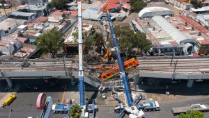 MEXICO CITY, MEXICO - MAY 04: Aerial view of the works to remove the damaged train after a train overpass collapsed last night killing 23 people on May 04, 2021 in Mexico City, Mexico. The accident happened between Olivos and Tezonco stations of metro line 12 at 10pm local time. (Photo by Hector Vivas/Getty Images)