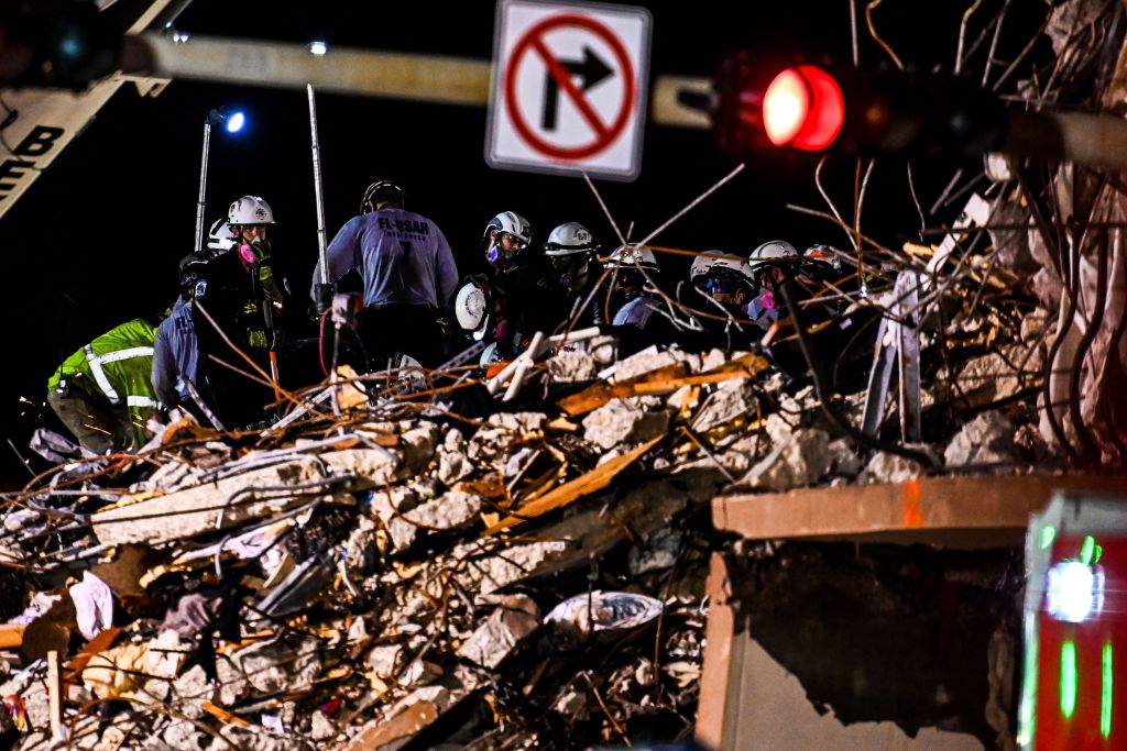 Search and rescue teams look for possible survivors in the partially collapsed 12-story Champlain Towers South condo building on June 30, 2021 in Surfside, Florida. - Four more bodies were discovered overnight in the rubble of a collapsed apartment building in Florida, authorities said Wednesday, as the search for more than 140 people unaccounted for entered its seventh day. The official death toll now stands at 16 after most of a building in the Miami-area town of Surfside suddenly pancaked early last Thursday, but hopes are dwindling that the hundreds of rescuers combing the oceanfront site will find anyone alive. (Photo by CHANDAN KHANNA / AFP) (Photo by CHANDAN KHANNA/AFP via Getty Images)