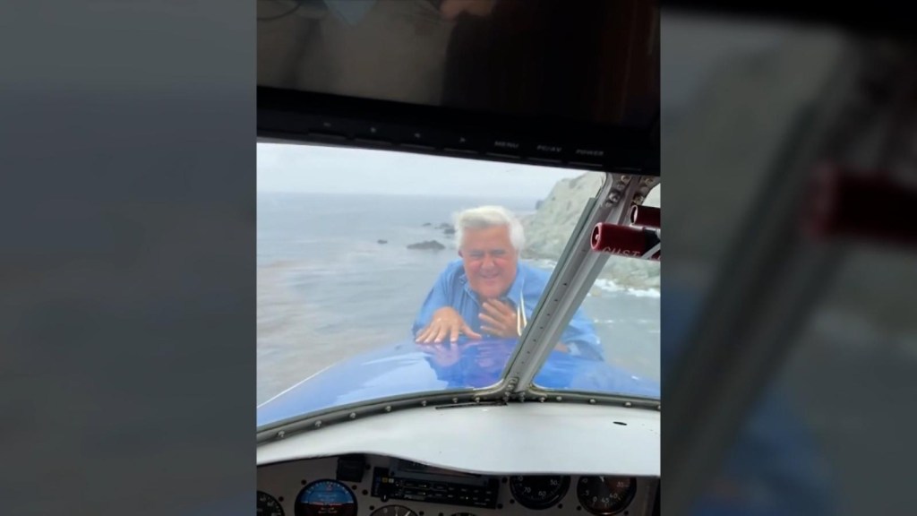 Jay Leno sticks his head out of the nose of the plane in the middle of the flight