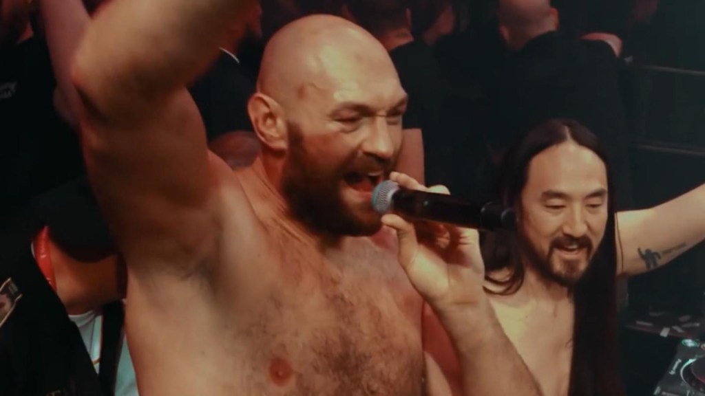 Tyson Fury sings for a crowd after beating Deontay Wilder