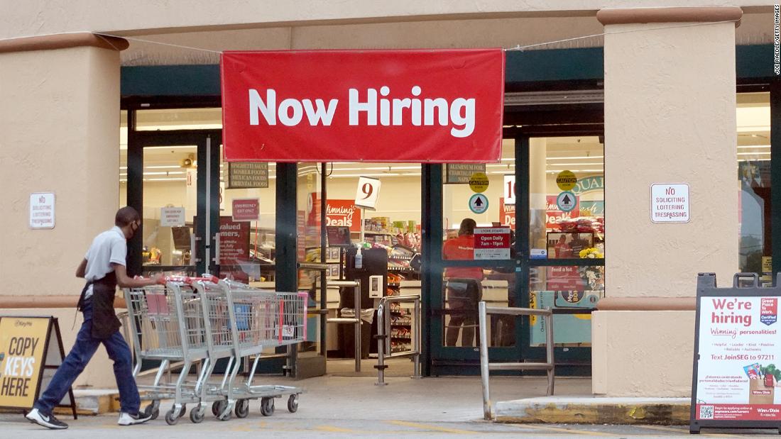 HALLANDALE, FLORIDA - SEPTEMBER 21: A Now Hiring sign hangs near the entrance to a Winn-Dixie Supermarket on September 21, 2021 in Hallandale, Florida. Government reports indicate that Initial jobless benefit claims rose 20,000 to 332,000 in the week ended Sept. 11. (Photo by Joe Raedle/Getty Images)