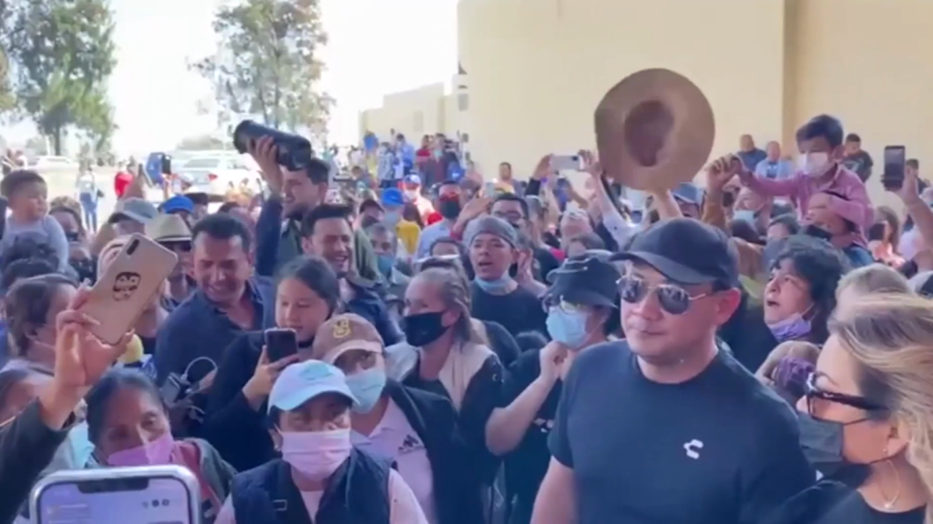 Fans cantan mientras esperan la llegada del cuerpo de Vicente Fernández