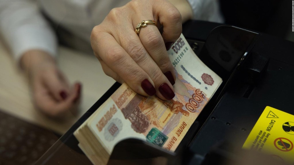 Russian stocks plummet and ruble falls to record low