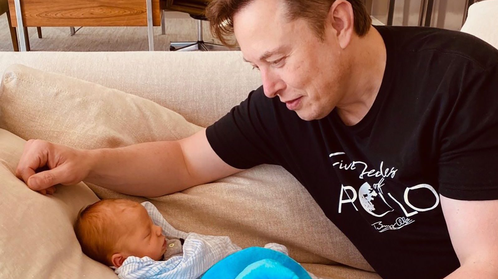 Musk looks at his new baby in this tweet posted by his mother in May 2020. The baby, named X Æ A-12, is his first child with Grimes.  She has five other children from a previous marriage. From Christiana Musk / Twitter