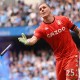 MANCHESTER, ENGLAND - MAY 22: Robin Olsen of Aston Villa removes a flare from the pitch during the Premier League match between Manchester City and Aston Villa at Etihad Stadium on May 22, 2022 in Manchester, England.