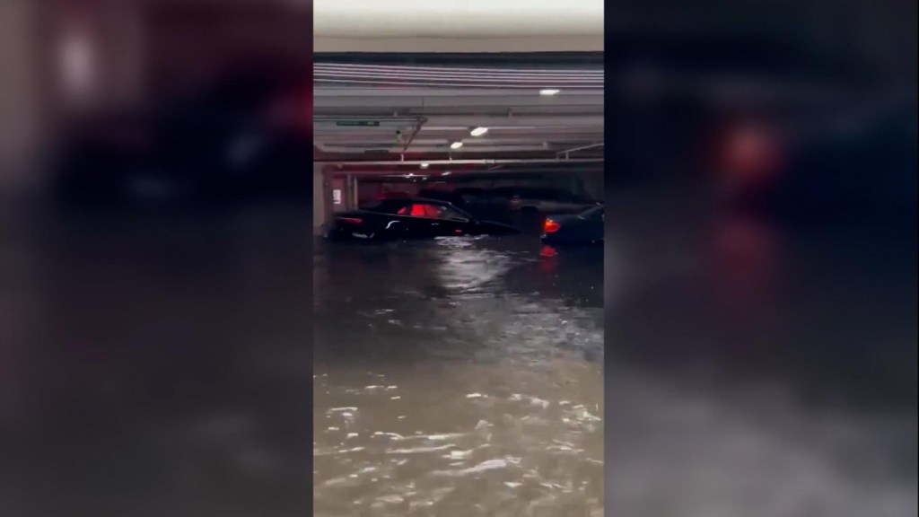 Hurricane Ian: Cars drift in parking lot after flooding
