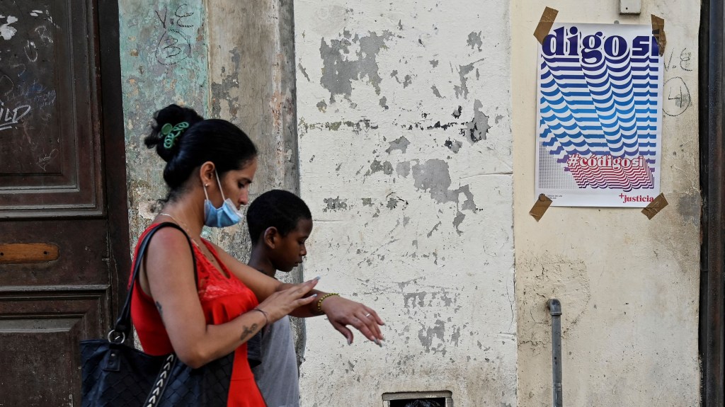 Una mujer y su hijo caminan frente a un cartel en favor del "Sí" en el referéndum que celebrará Cuba el 25 de septiembre y que podría legalizar el matrimonio gay