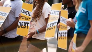Activistas sostienen carteles de cancelación de la deuda estudiantil mientras se reúnen para manifestarse frente a la Casa Blanca en Washington D. C., el 25 de agosto de 2022.