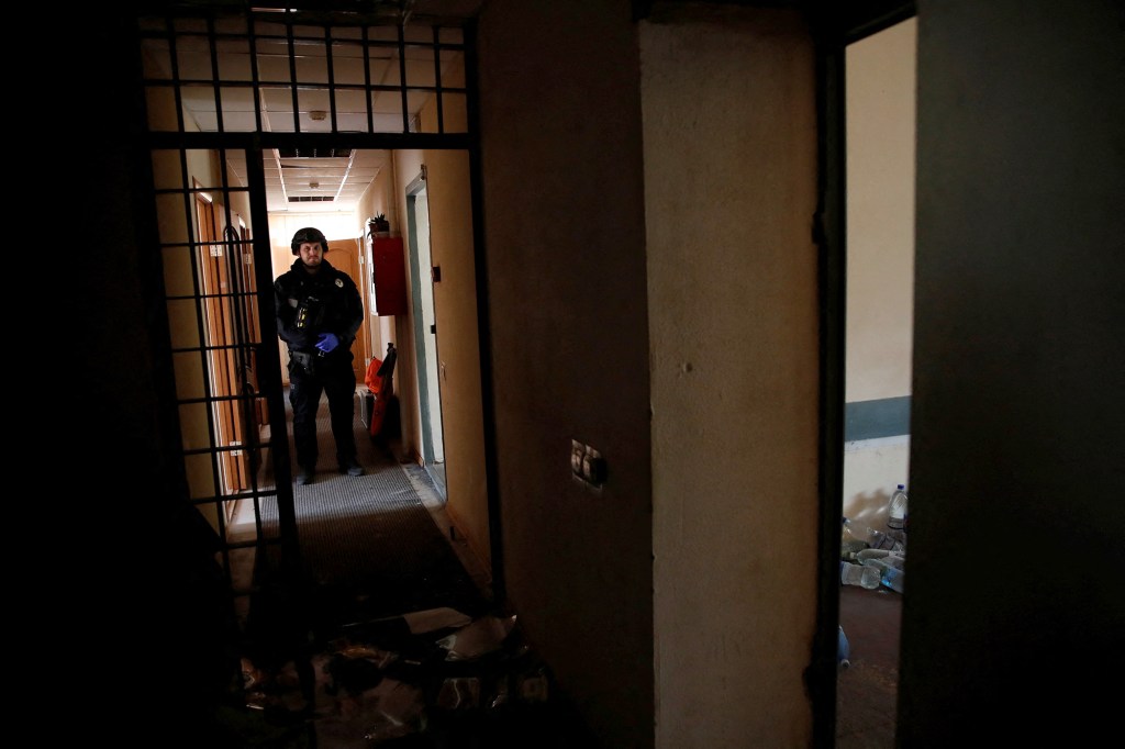 Un policía ucraniano se encuentra en un centro de detención provisional que, según los ucranianos, fue utilizado por miembros del servicio ruso para encarcelar y torturar a personas en Jersón, Ucrania, el 16 de noviembre. (Foto: Murad Sezer/Reuters)