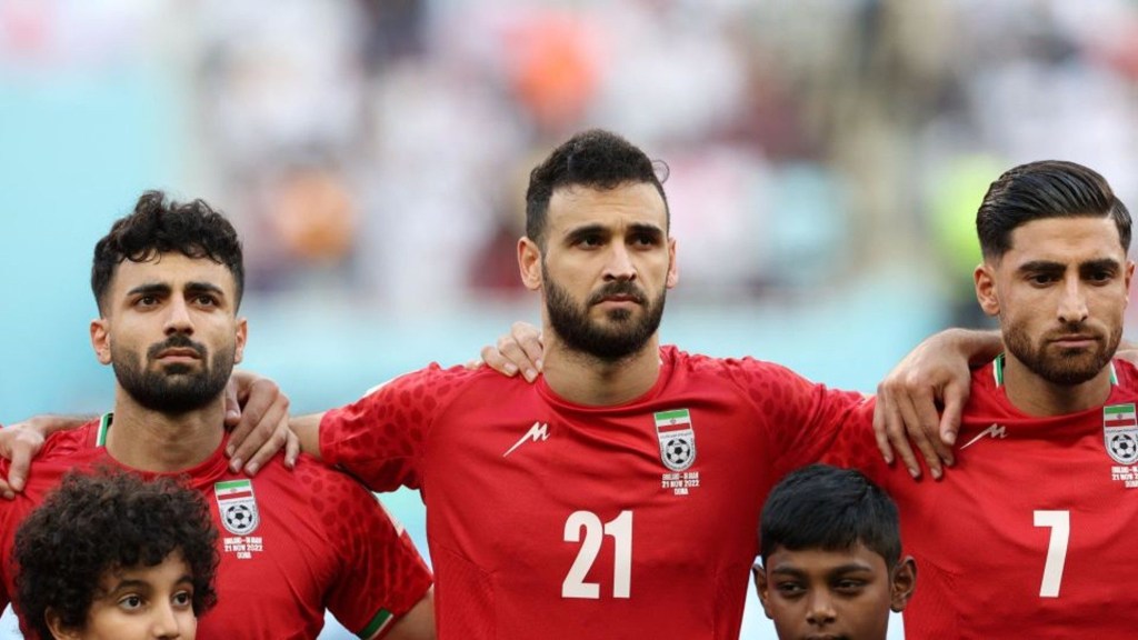 From left to right: Sadegh Moharrami, Ahmad Noorollahi and Alireza Jahanbakhsh during the anthem during Iran's match against England in the group stage of the World Cup in Qatar.