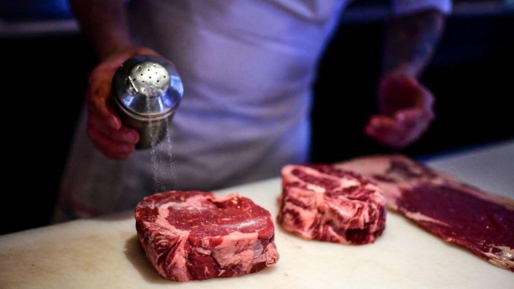 A chef prepares pieces of meat for cooking at the Don Julio restaurant in the Palermo neighborhood of Buenos Aires, on May 20, 2021.  (Credit: Ronaldo Schmidt/AFP/Getty Images)