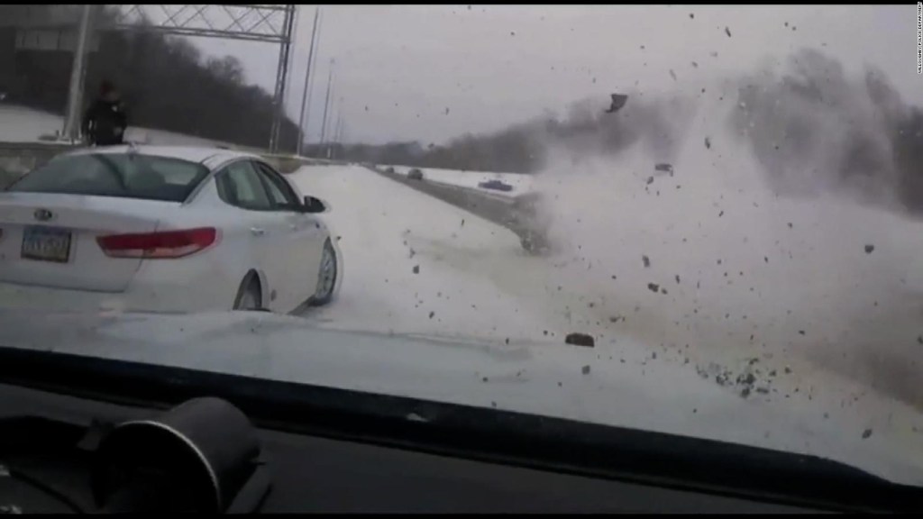 Policeman saves himself from being run over on a highway