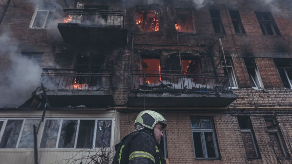 Ukrainian firefighters extinguish a fire after a shelling by the Russian army in Bakhmut, Ukraine, on December 7, 2022. (Credit: Diego Herrera Carcedo/Anadolu Agency/Getty Images)