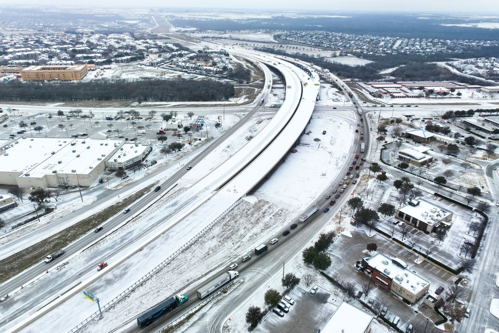 A mix of ice covers Highway 114 in Roanoke, Texas, on Monday.  (Credit: Lola Gomez/The Dallas Morning News via AP)