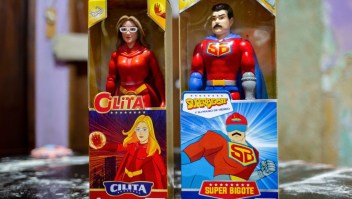 Toys in superhero costumes known as "Super Mustache" and "Cilita", inspired by Venezuelan President Nicolas Maduro (R) and his wife, Cilia Flores (L), are pictured in a house in a community of the Catia neighbourhood in Caracas on December 26, 2022. - The superhero figure known as "Super Mustache" began circulating in cartoons in 2019 as a character who fights the United States and its allies with the slogan "With his iron hand". According to Venezuelan Vice President Delcy Rodriguez, during the Christmas festivities, the government distributed 12 million toys among children, some of whom were "Super Mustache" and "Cilita". (Photo by Pedro MATTEY / AFP) (Photo by PEDRO MATTEY/AFP via Getty Images)