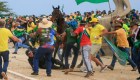Un agente de la Policía Militar cae de su caballo durante los enfrentamientos con simpatizantes de Bolsonaro tras una invasión al Palacio Presidencial de Planalto. (SERGIO LIMA/AFP vía Getty Images)
