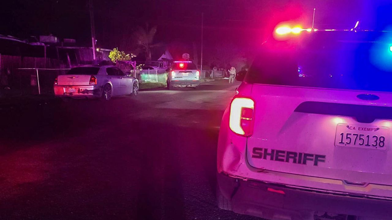 In this image released by the Tulare County Sheriff's Office, detectives investigate a shooting in Goshen, California early Monday morning.