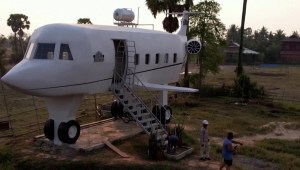 Un camboyano construye una casa con forma de avión