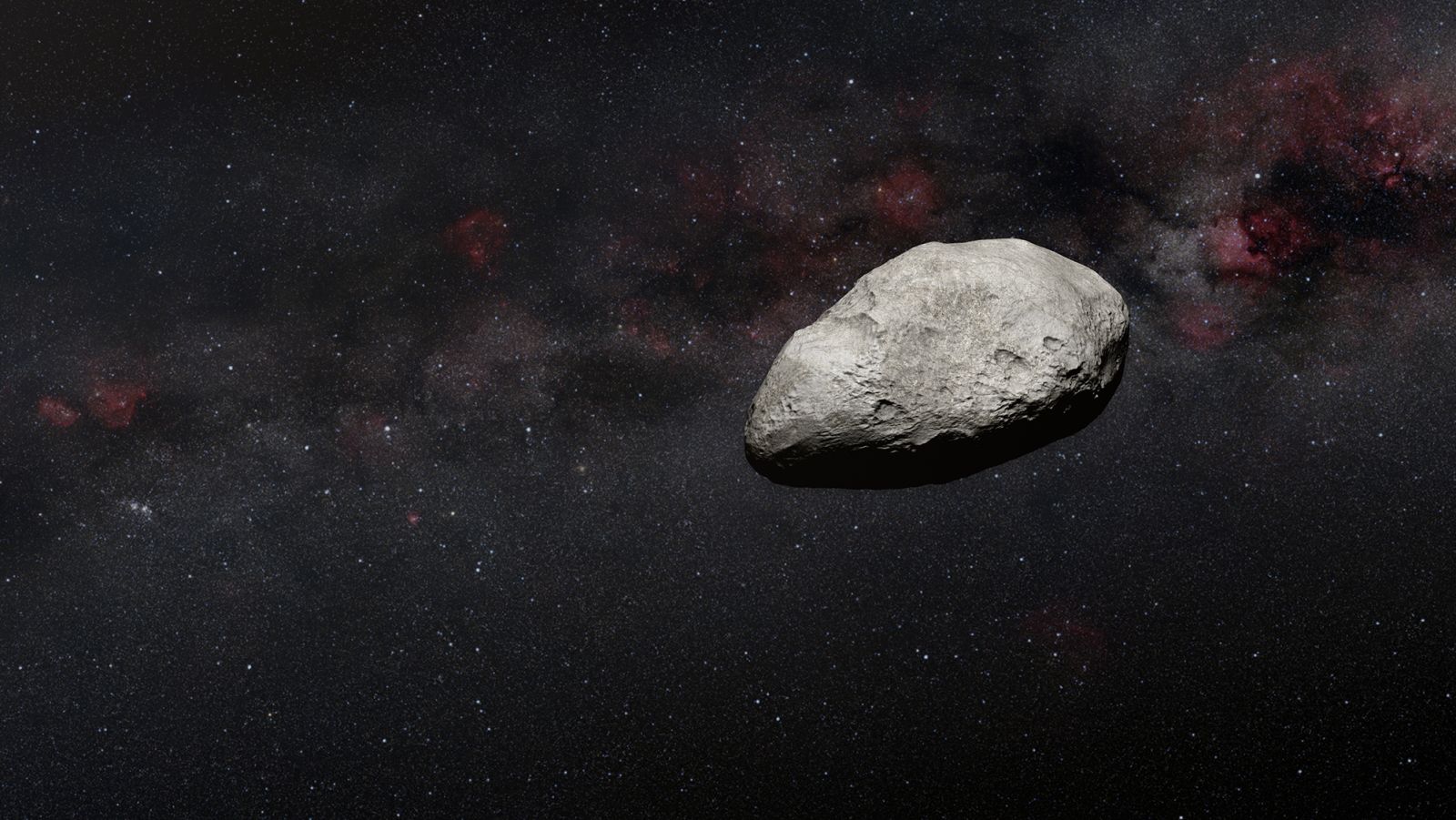 La ilustración de un artista muestra un asteroide gris de forma irregular similar al nuevo objeto detectado por el telescopio Webb.