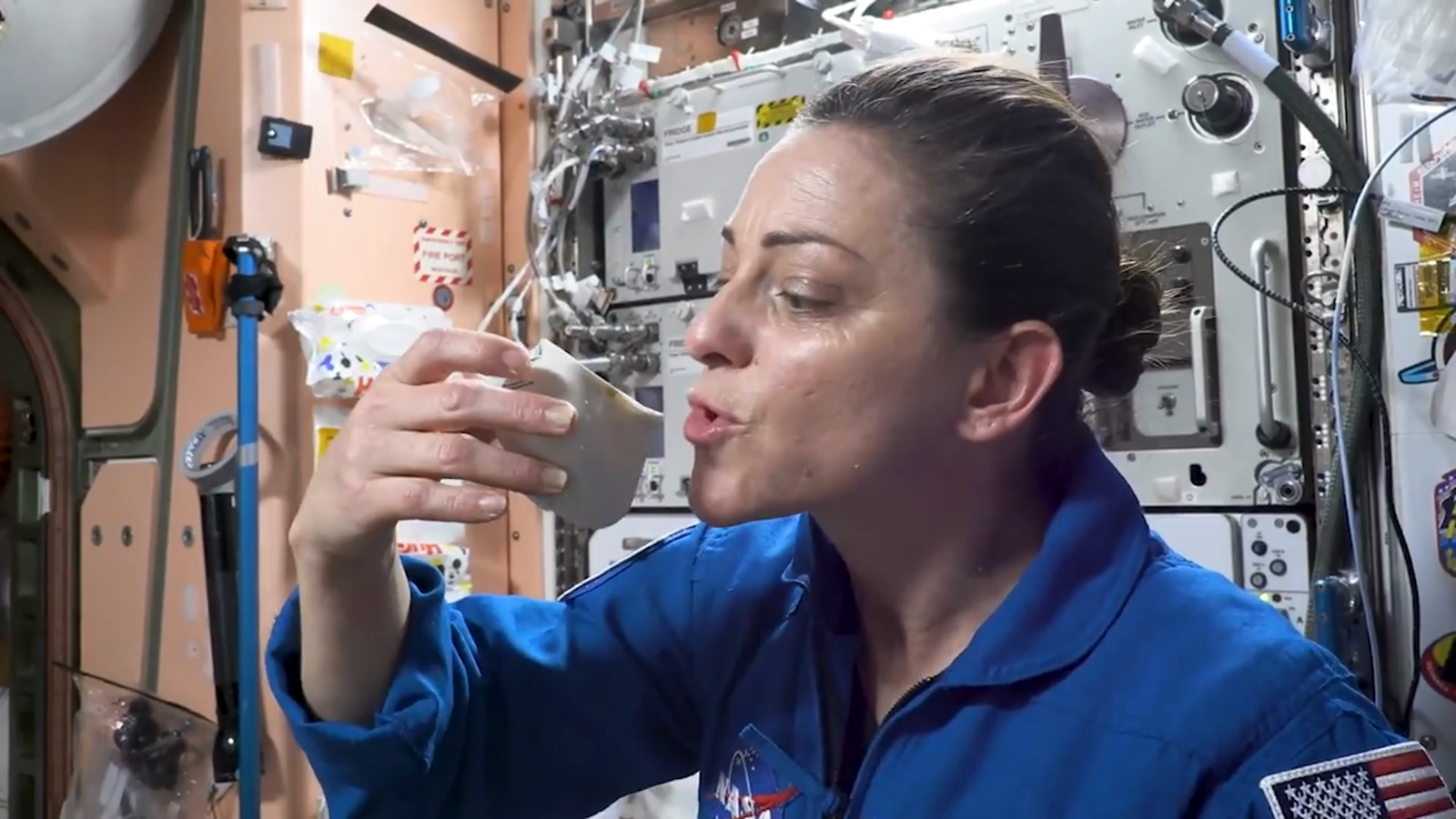An astronaut showing how to make coffee in space