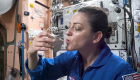 An astronaut showing how to make coffee in space