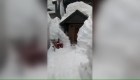 A California resident walks through a snow tunnel to get home