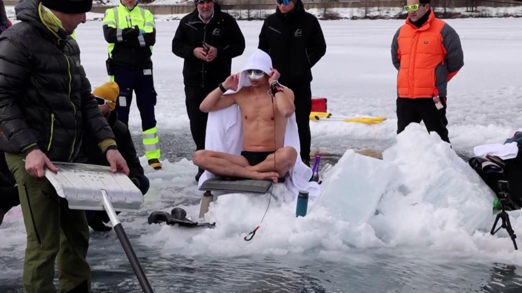 A diver dives more than 50 meters into a frozen lake