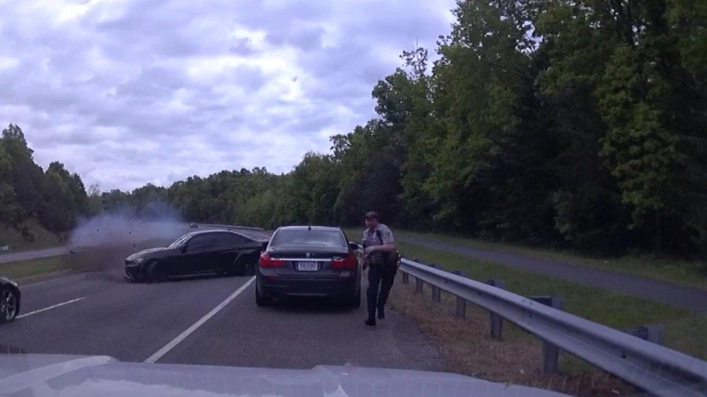 Watch the moment a police officer narrowly dodges a car