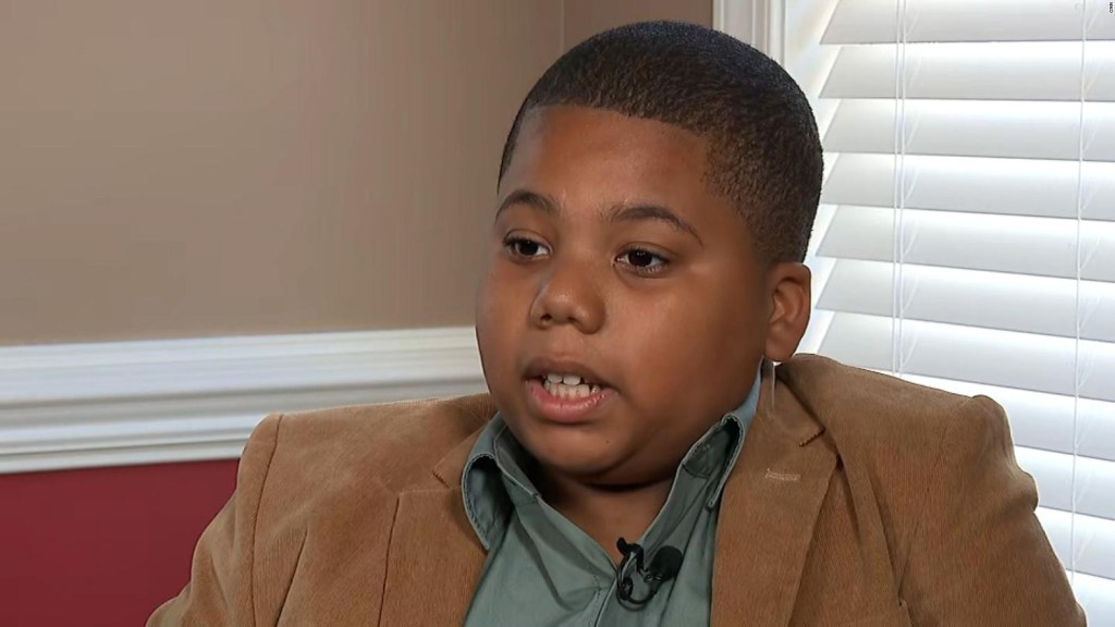 Boy says he looks at himself in a coffin after being shot by a police officer