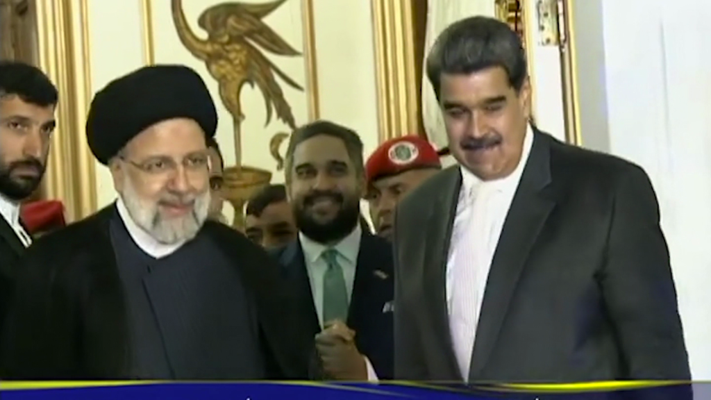 Why did the president of Iran travel to Venezuela?
