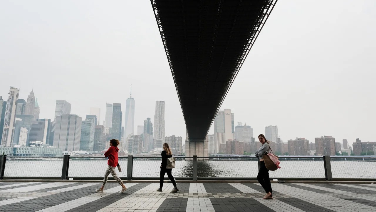 La gente camina por un parque de Brooklyn en la ciudad de Nueva York el martes por la mañana. Los niveles de contaminación del aire no eran saludables para los grupos sensibles debido al humo de los incendios forestales de Canadá.