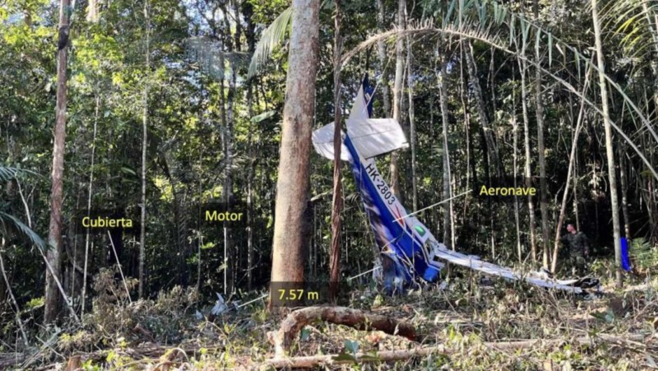 Photos of the crash site taken by investigators show the raised tail of an aircraft painted blue and white with a destroyed front end.  (Credit: Accident Investigation Technical Department)