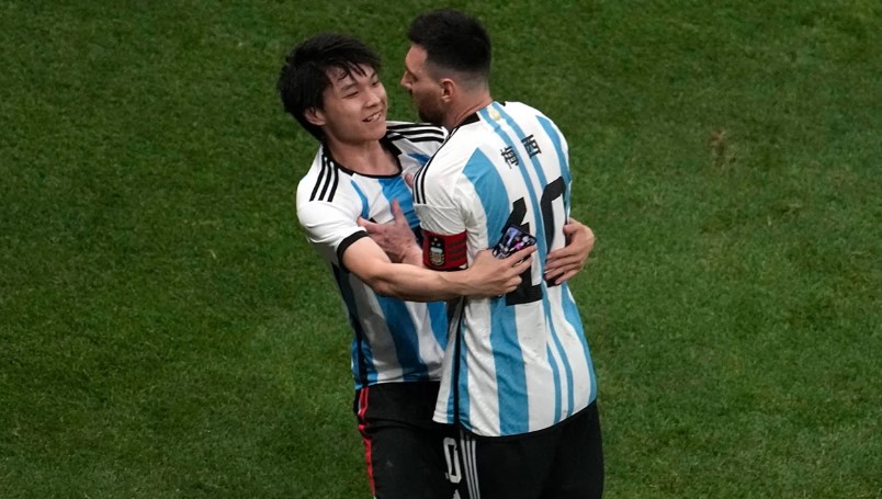 A Chinese fan runs onto the pitch to hug soccer superstar Lionel Messi during a friendly match between Argentina and Australia at Workers' Stadium in Beijing June 15.  (Credit: Ng Han Guan/AP)