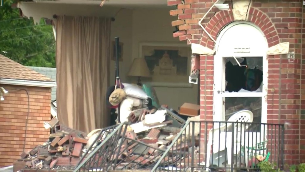 A car goes flying and crashes into a house.