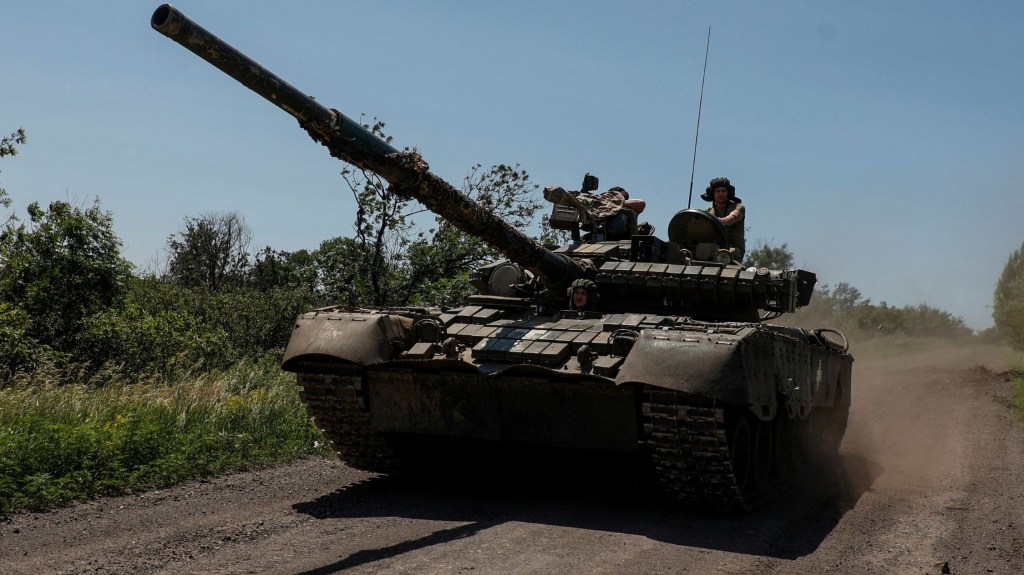 Militares ucranianos montan en un tanque de batalla principal T-80 capturado anteriormente a las tropas rusas, a lo largo de una carretera cerca de la ciudad de Bakhmut, en la línea del frente, el 19 de junio. (Foto: Serhii Nuzhnenko/Radio Free Europe/Radio Liberty/Reuters)