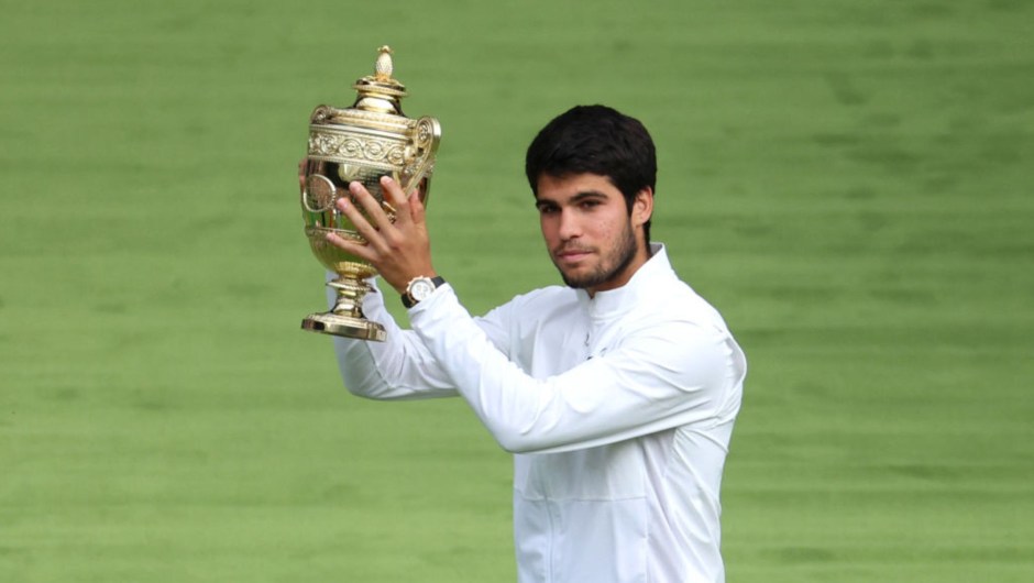 Carlos Alcaraz lifts his champion's trophy after winning the 2023 Wimbledon final against Novak Djokovic.  (Photo: Patrick Smith/Getty Images)