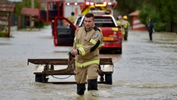 Un bombero ayuda en la evacuación de residentes atrapados en la inundada ciudad de Cabrero, en Bío Bío, Chile, el 21 de agosto de 2021. (Crédito: GUILLERMO SALGADO/AFP via Getty Images)