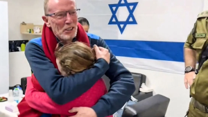 Emily Hand abraza a su padre en un hospital de Israel después de ser liberada por Hamas el 25 de noviembre. (Crédito: Ejército de Israel/AFP vía Getty Images)