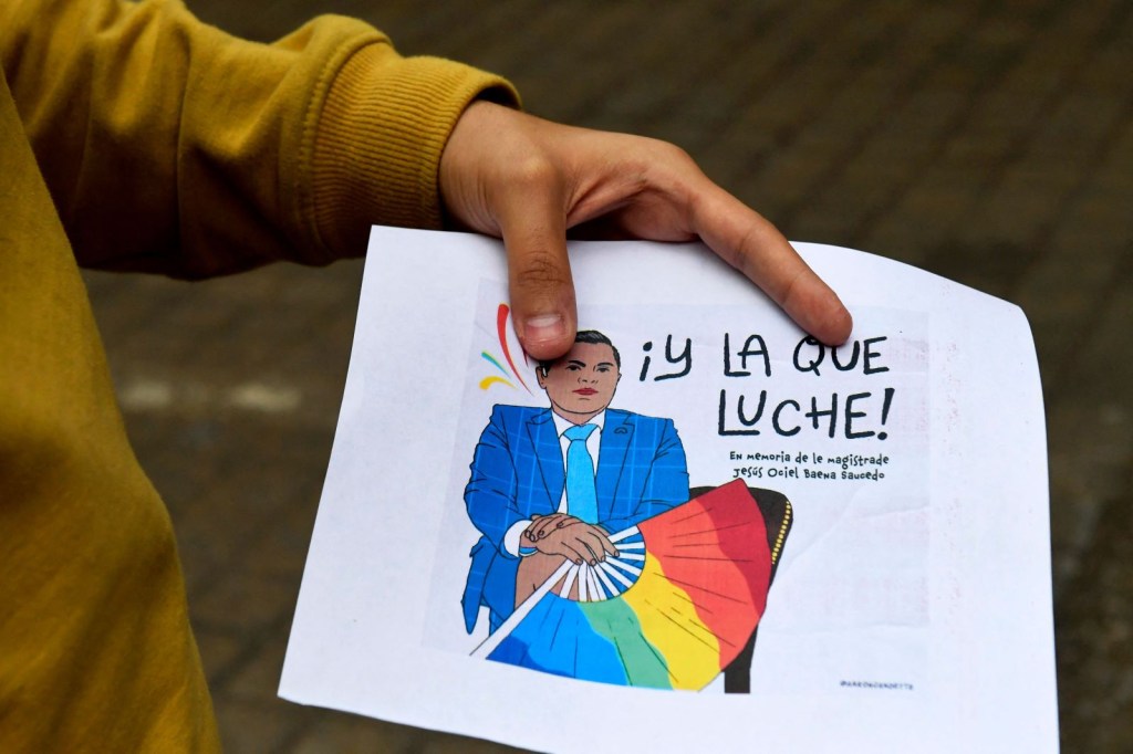 Un estudiante sostiene un cartel durante una ofrenda en honor a Jesús Ociel Baena en la Facultad de Ciencias Políticas y Sociales de la Universidad Nacional Autónoma de México, en Ciudad de México, el 14 de noviembre de 2023. (Foto de CLAUDIO CRUZ/AFP vía Getty Images)